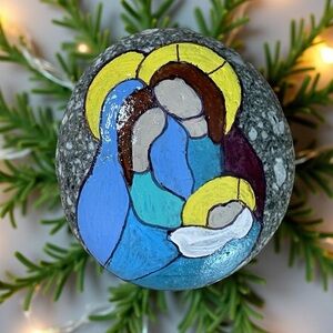 Hand crafted painted nativity rock natural background Mary Joseph Baby Jesus